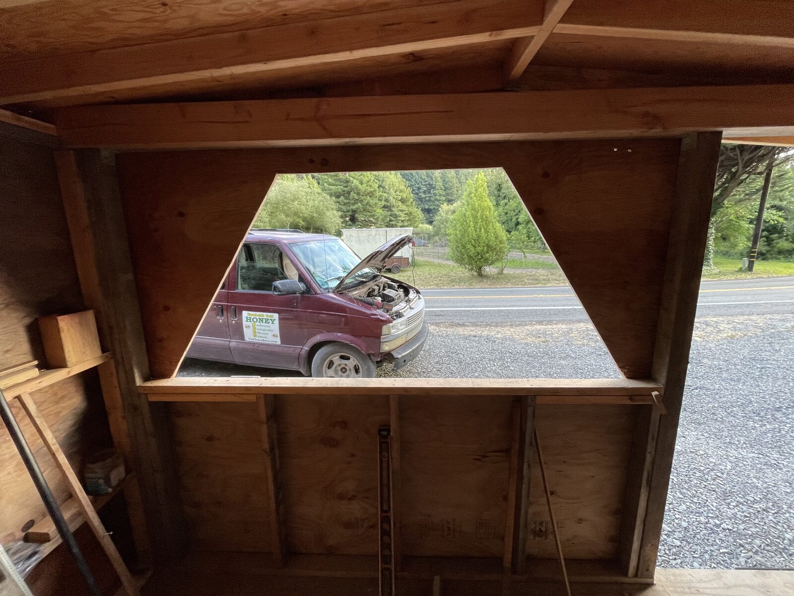 The serving window opening seen from inside the stand, looking out at the road